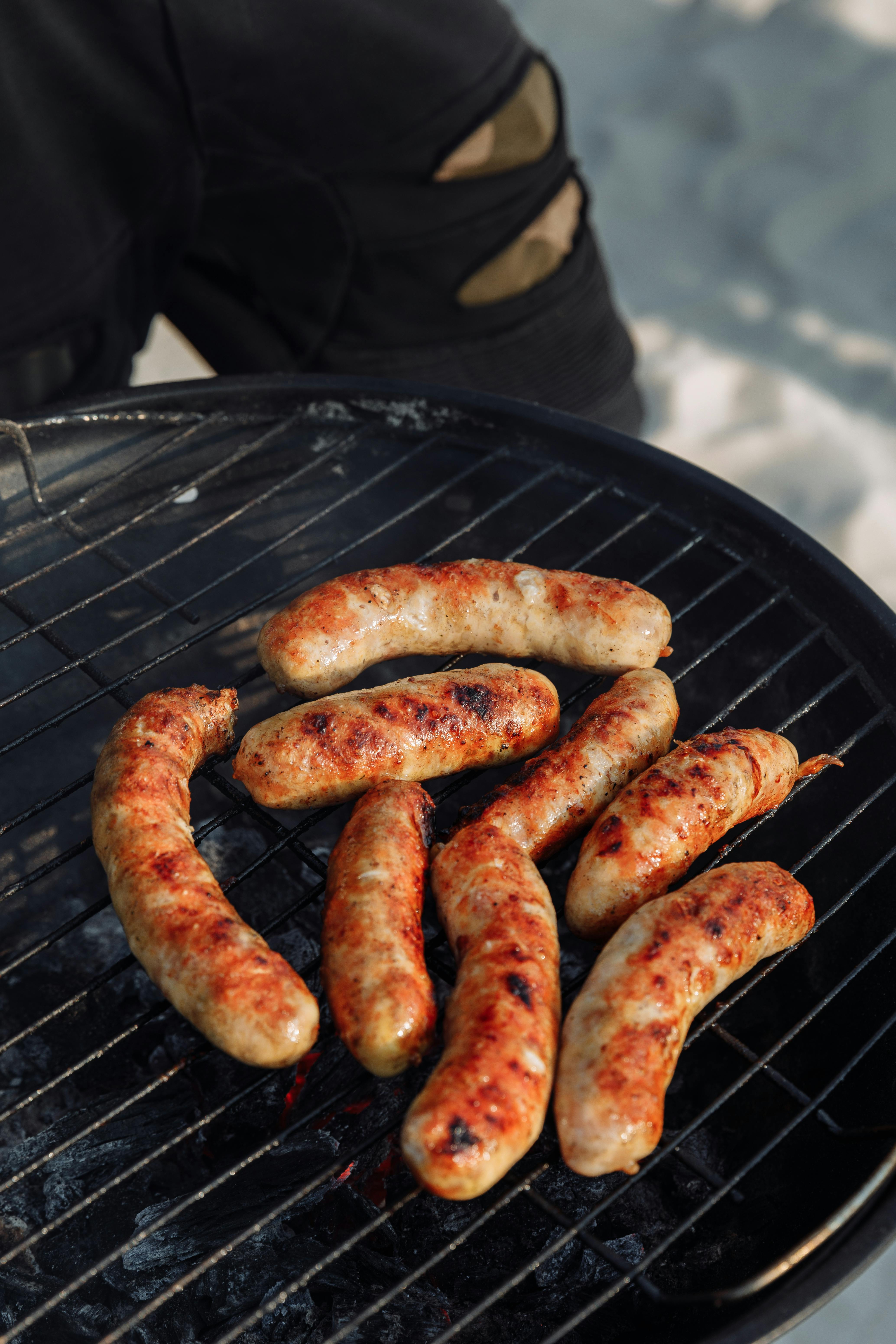 Juicy grilled sausages on a charcoal grill